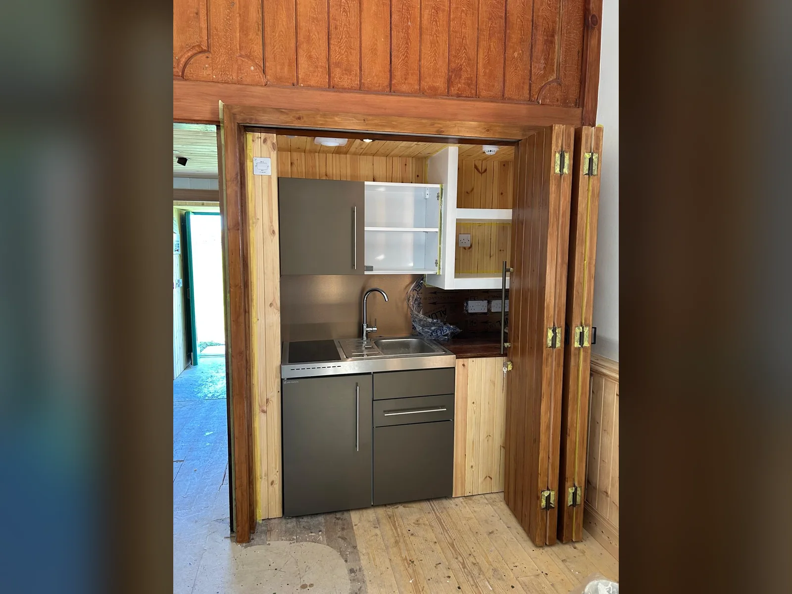 The kitchenette at Papa Stour Kirk, built into the fit-out with the ledged and braced doors made off site in our workshop
