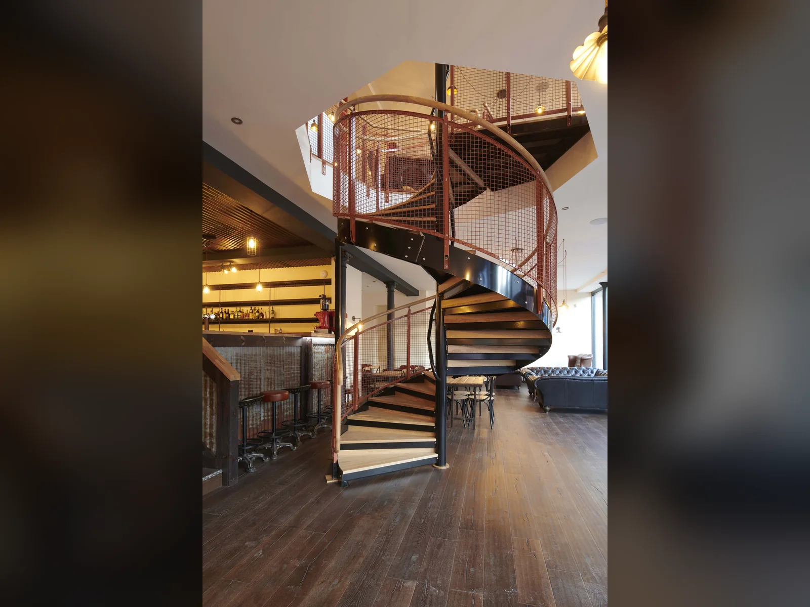The spiral stair at Rose Street Foundry, rising through the new floor structure between the original cast iron columns