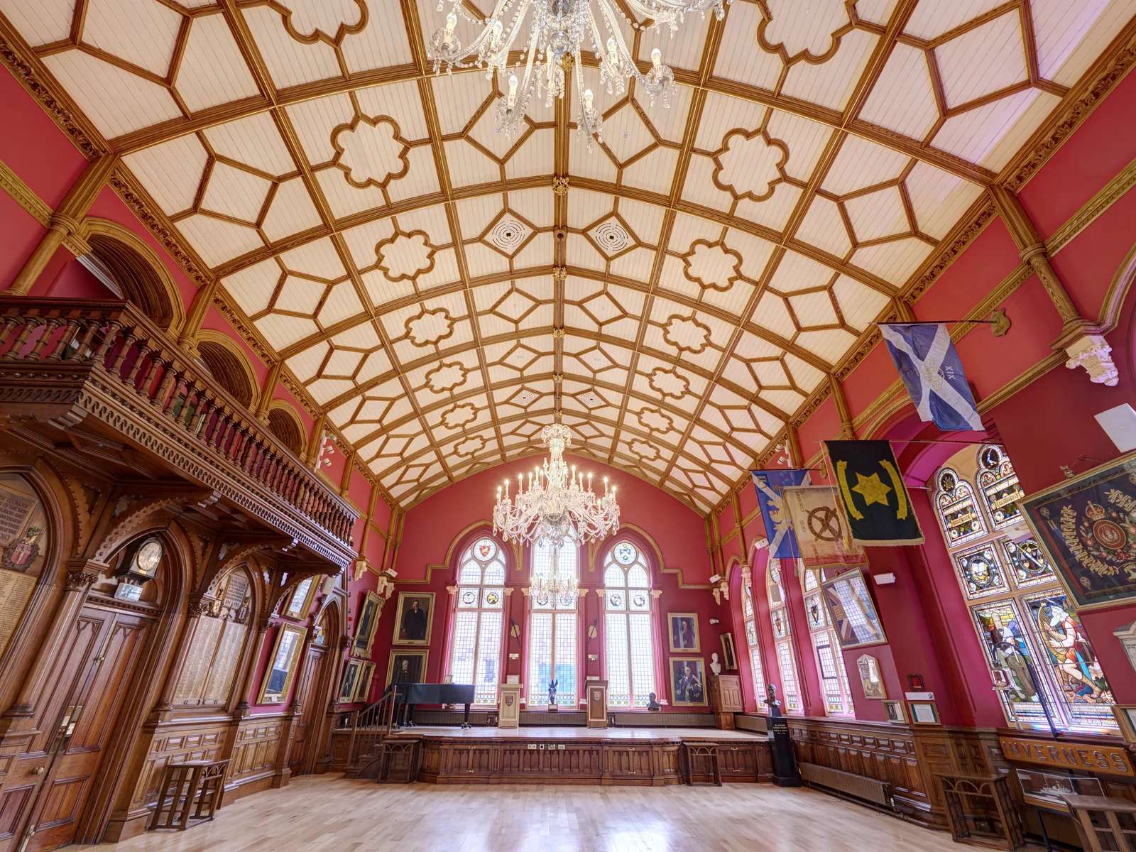 The Main Hall at Inverness Town House, its vaulted ceiling ribs timber grained and gold leafed and the walls returned to their deep red