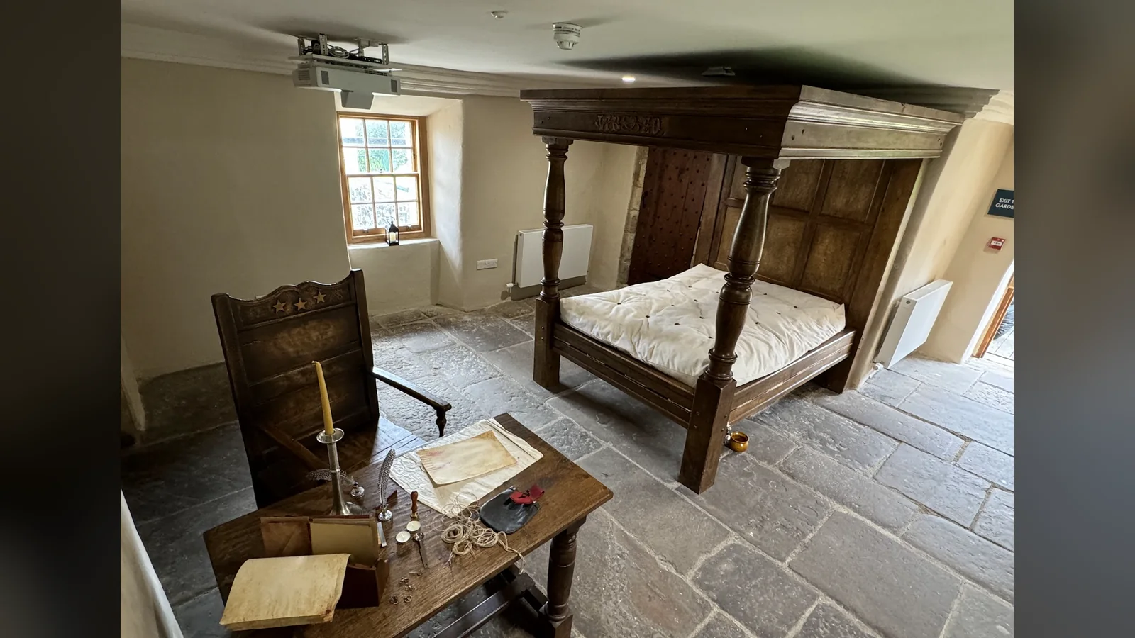Provan Hall, Glasgow: the period bed chamber in the north block, with the restored first-floor plaster and the re-laid stone floor