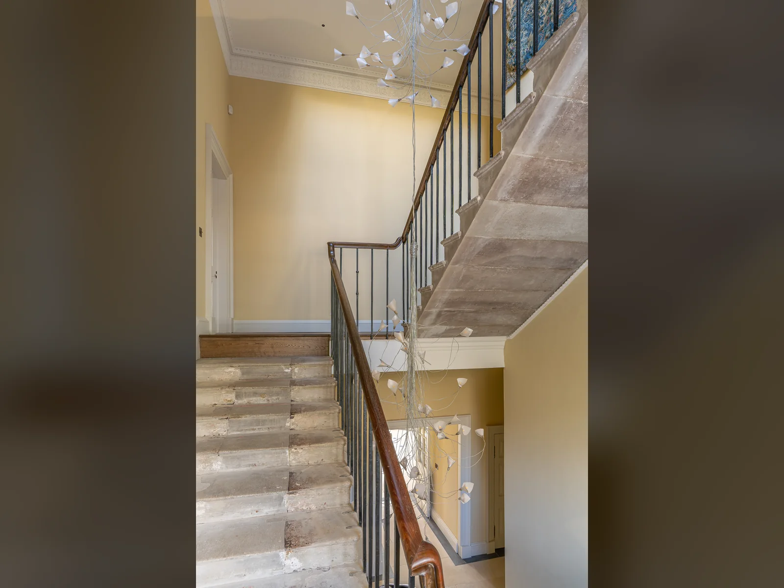The entrance hall and stone stair at Asknish House, plastered, panelled and decorated after two decades of dereliction