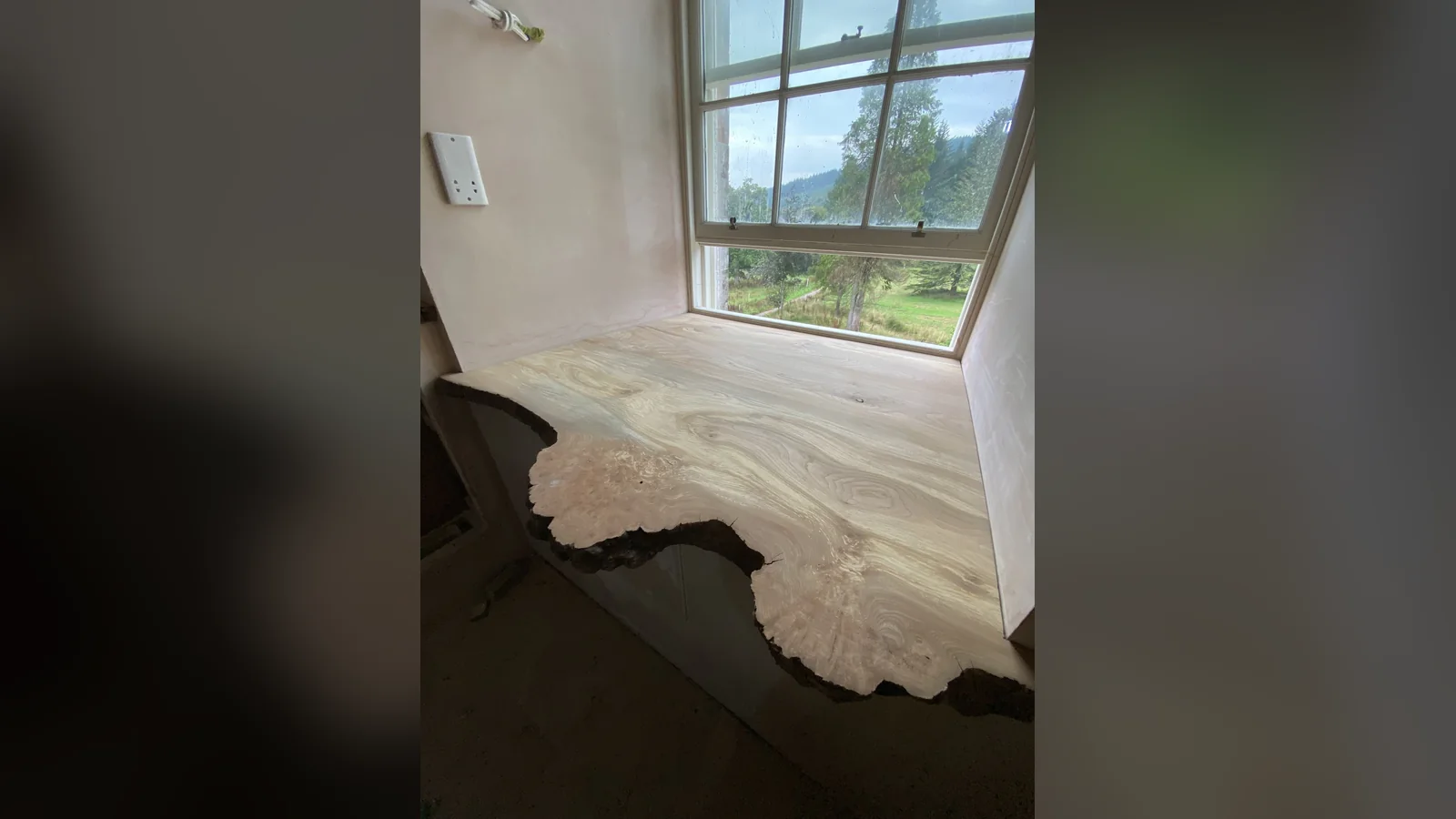 Asknish House: a lime plastered window reveal and timber window seat, the insulating lime plaster system taken into the reveal