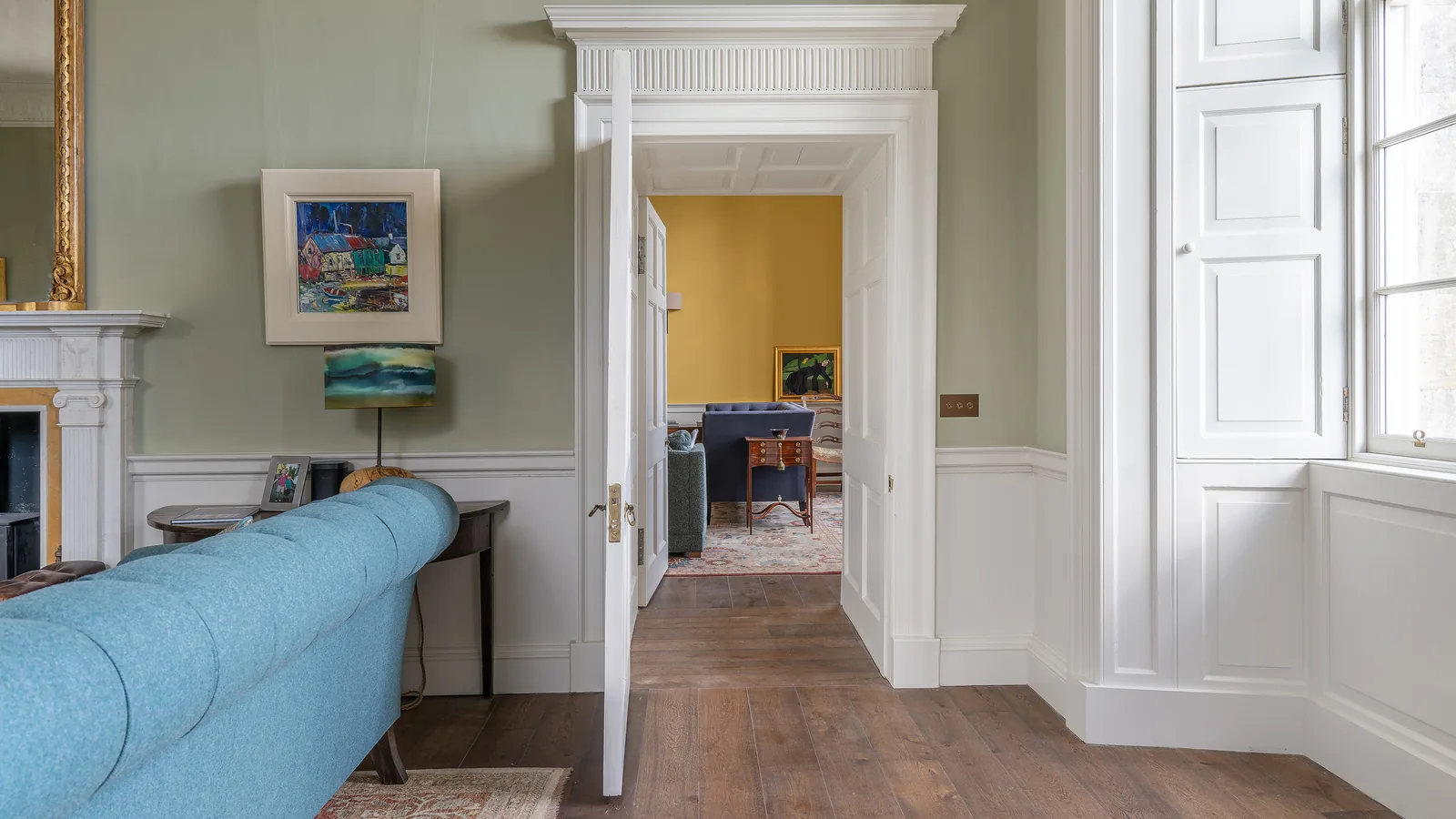 Asknish House: a pedimented doorcase and folding shutters in the drawing room