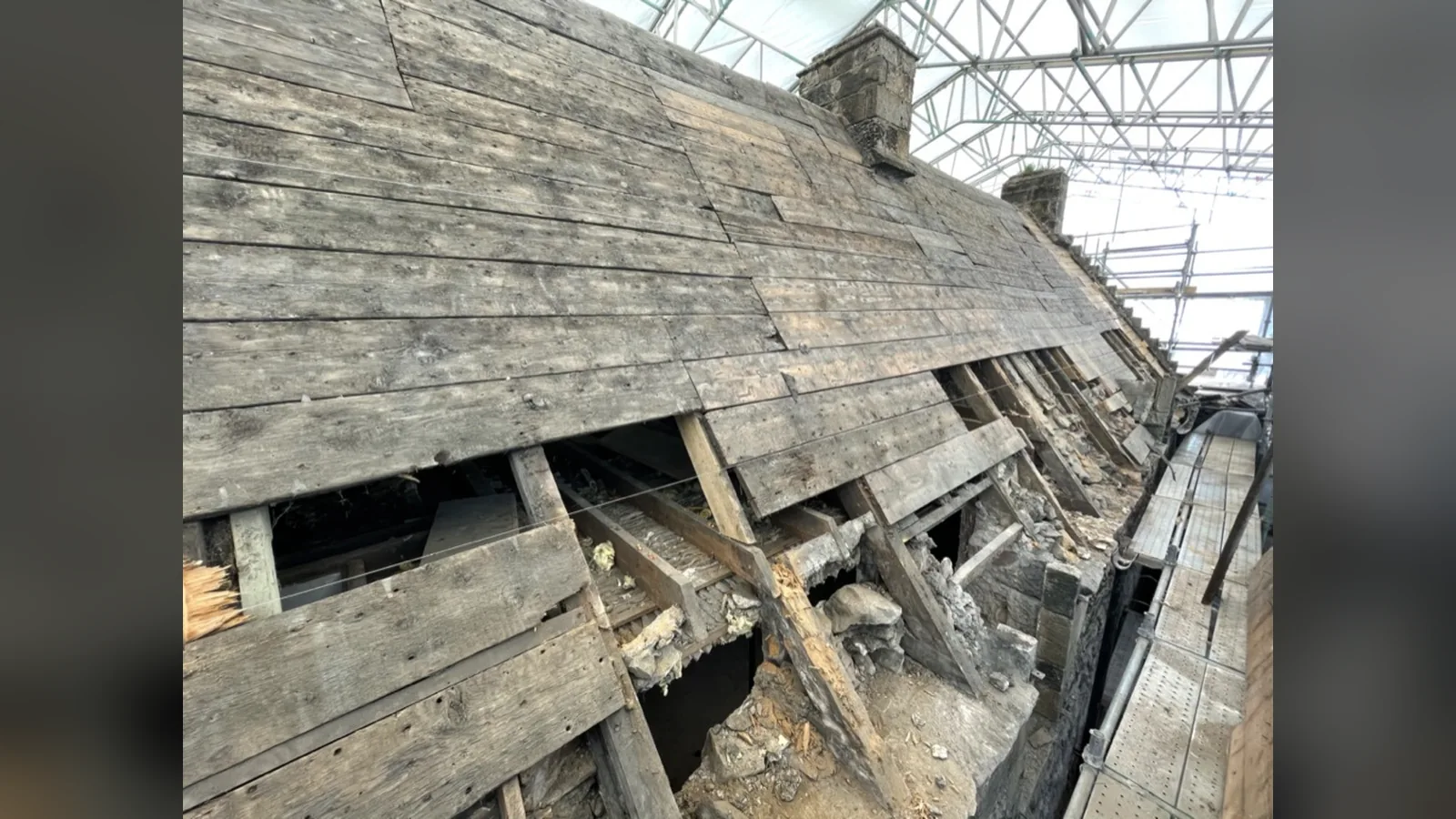 Provan Hall: the north block rafter feet opened up at the wallhead under the temporary roof, the decayed ends exposed where the water had run