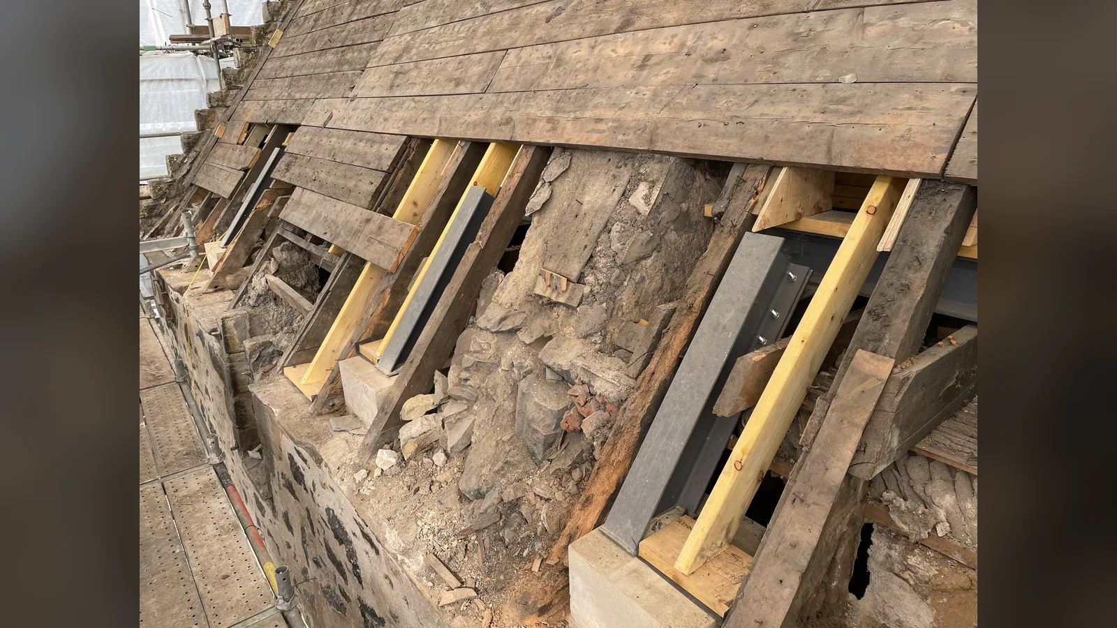 Provan Hall: rafter feet repaired at the north block wallhead, new timber sistered to the originals and steels bolted in on new padstones, under the original sarking