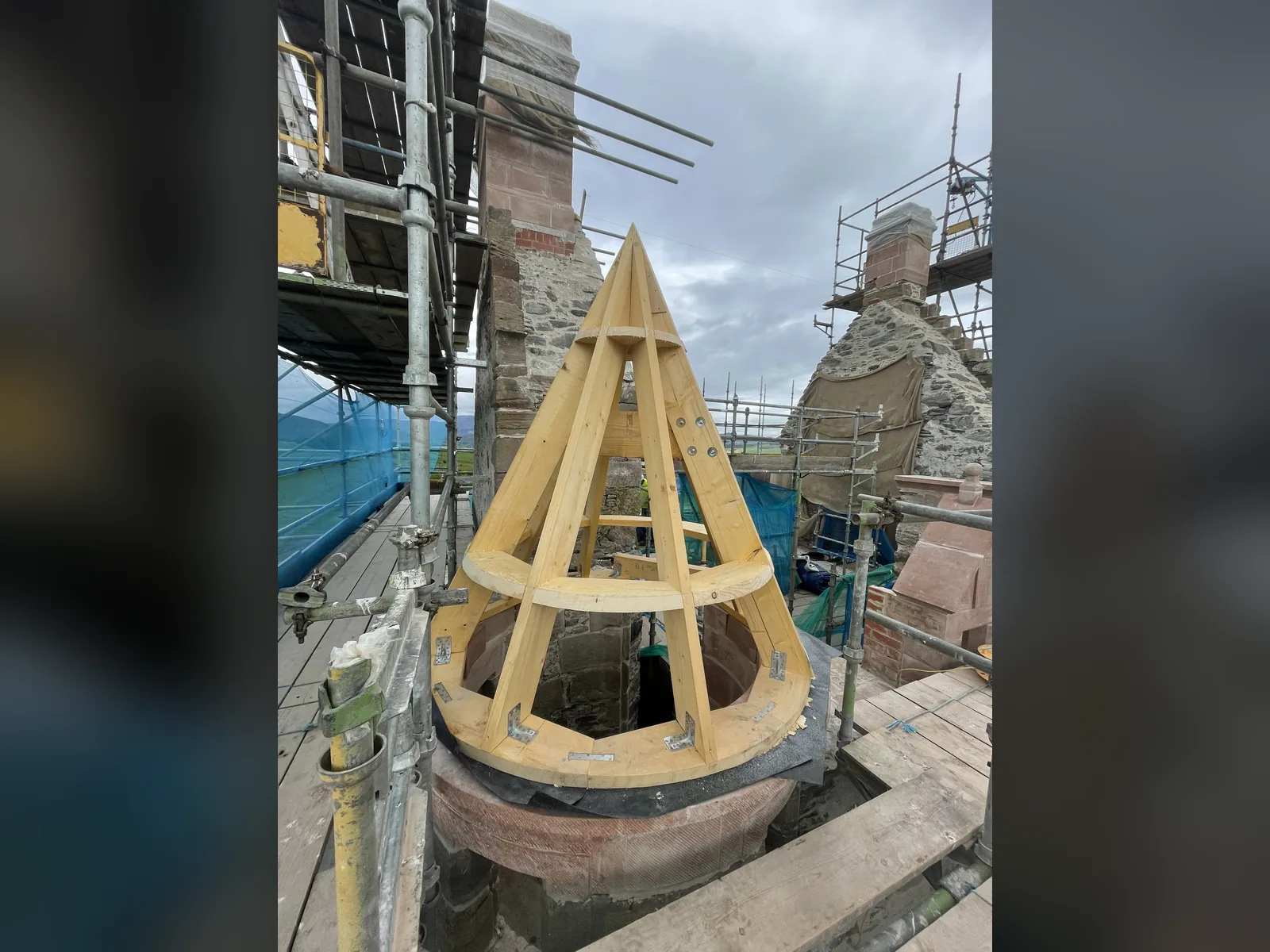 Fairburn Tower: the conical roof of a bartizan framed in timber on its new sandstone base