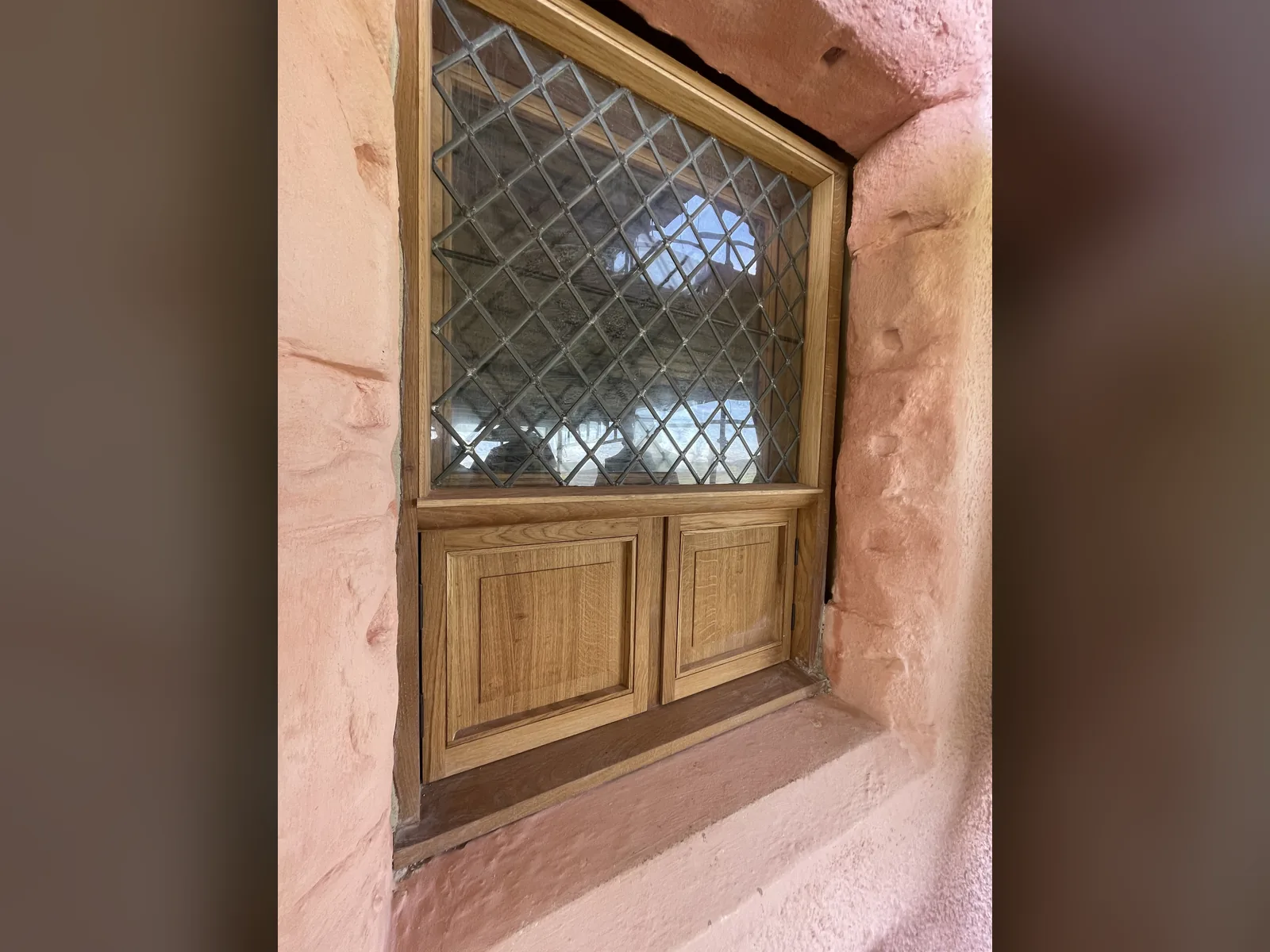 Fairburn Tower: a new timber window with a leaded light and panelled lower section fitted into a sandstone reveal