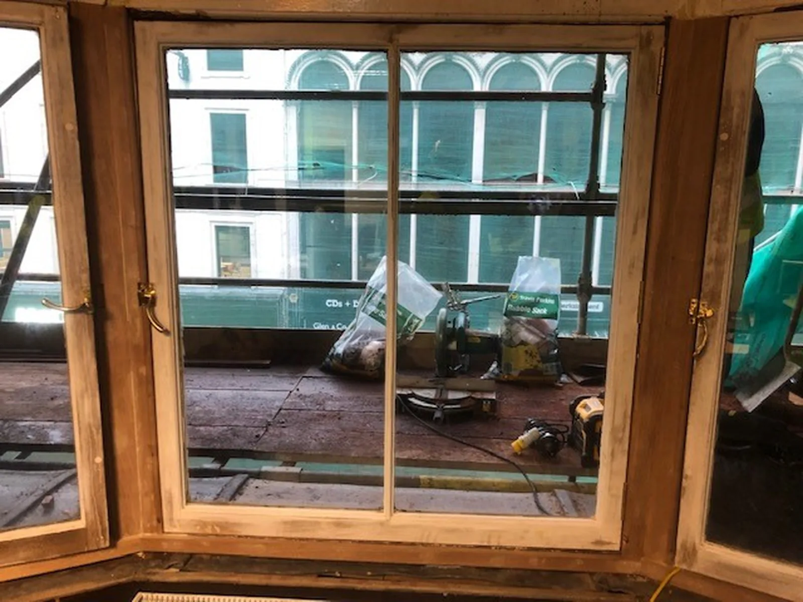 186 Argyle Street: repaired casements back in the bay, with the glazing protected while the frame is made good