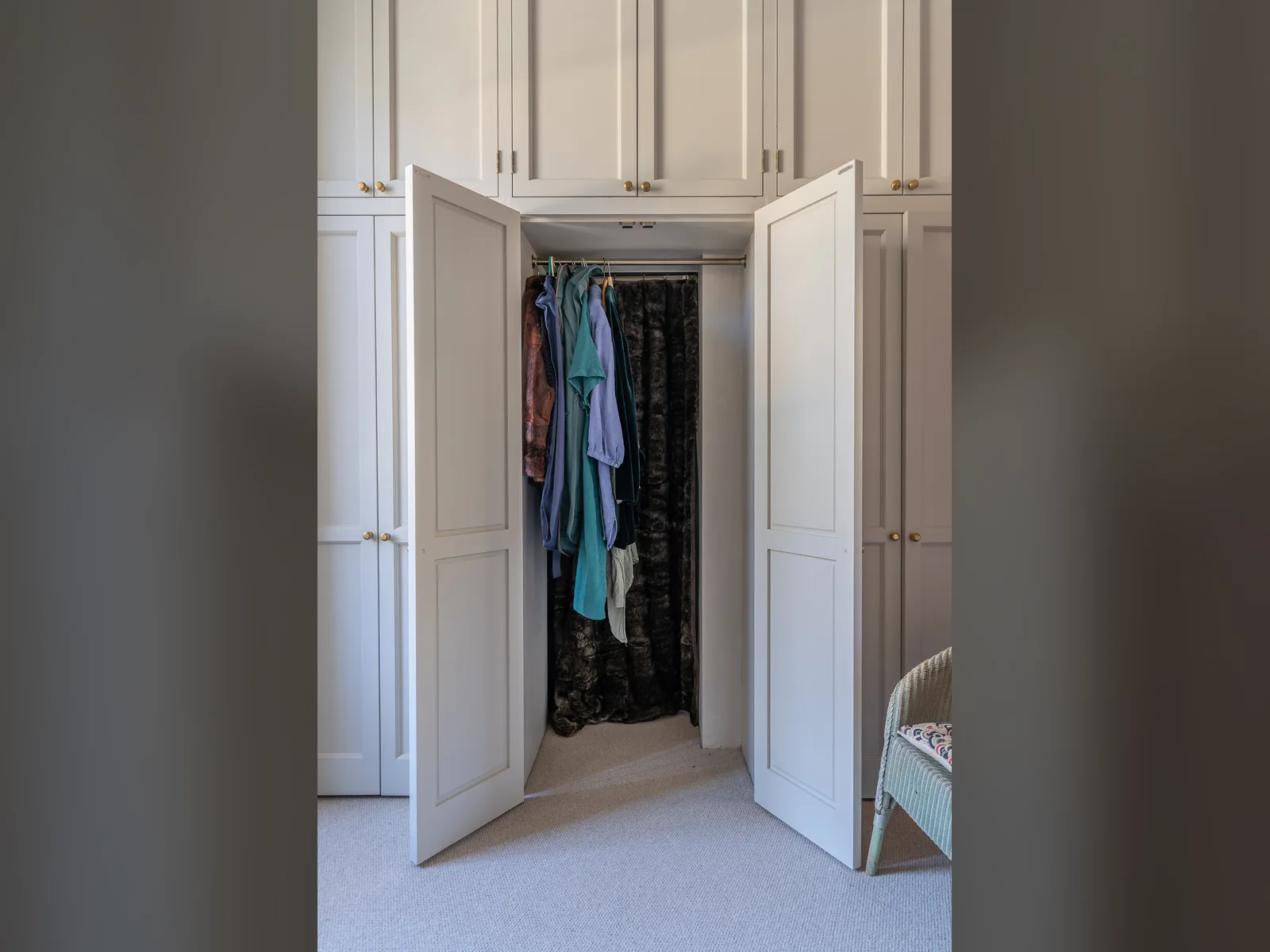 Asknish House: built-in cupboards with panelled doors framing a bedroom doorway