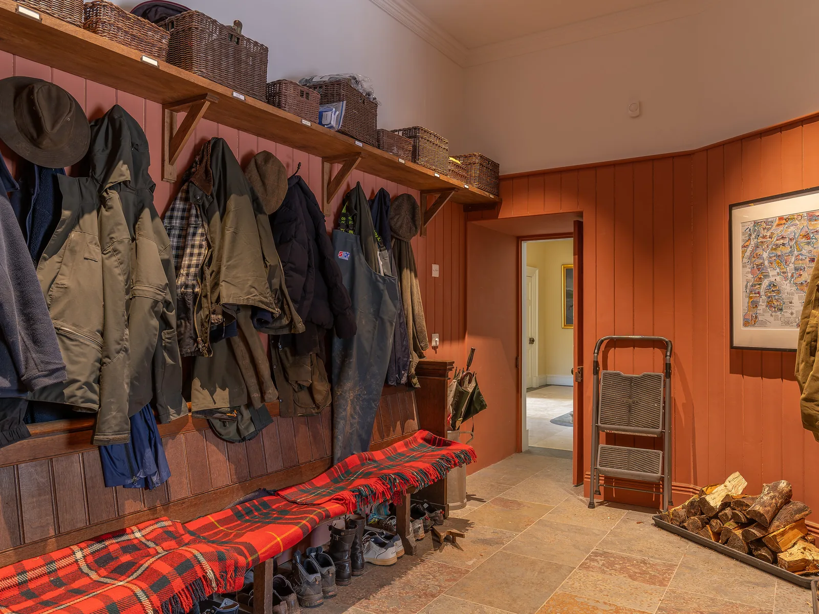 Asknish House: the boot room lined in vertical boarding, with a fitted bench and shelf