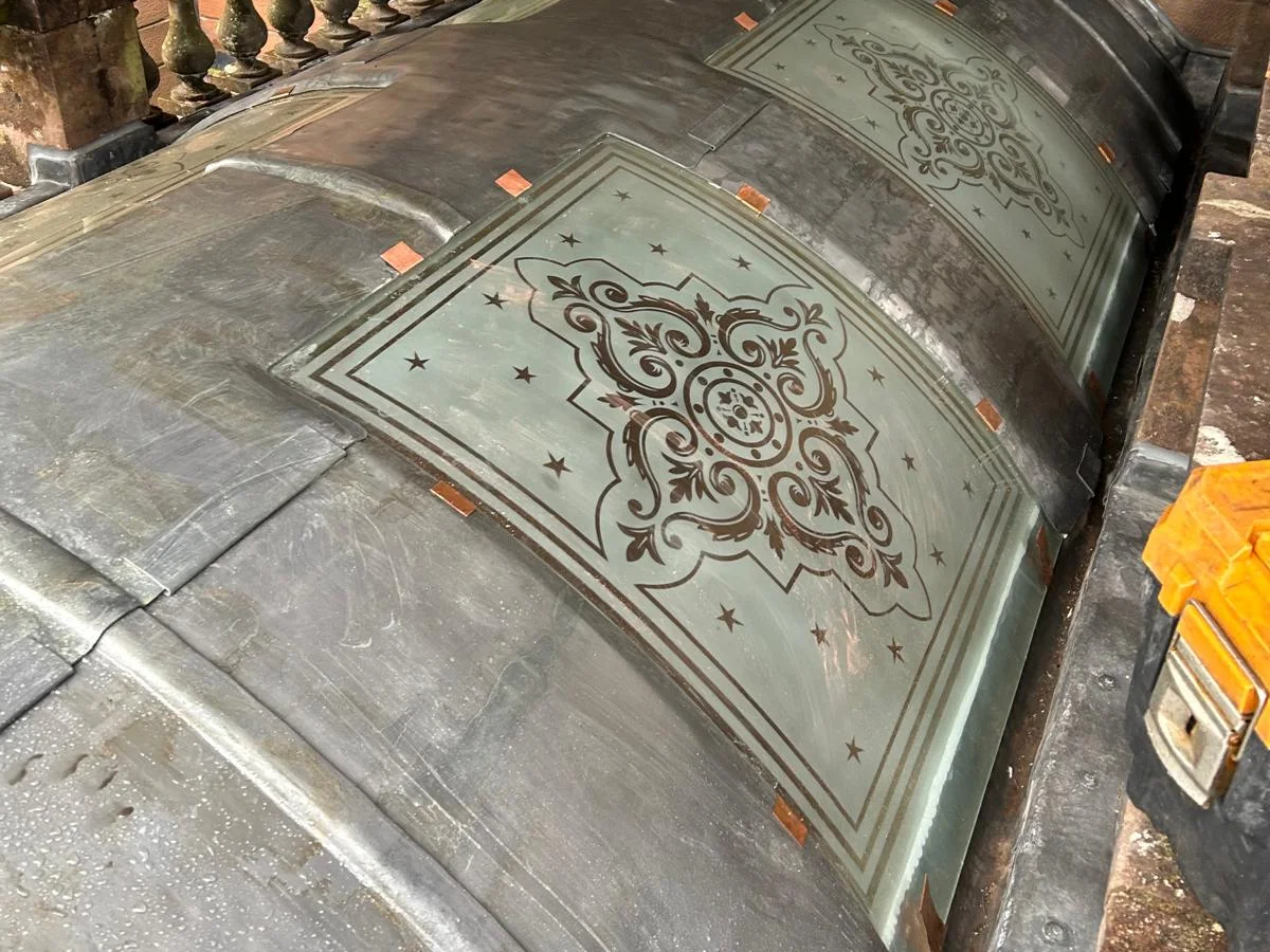 A curved lead roof with etched glass lights set into it, each pane held on copper tingles and the lead dressed around it