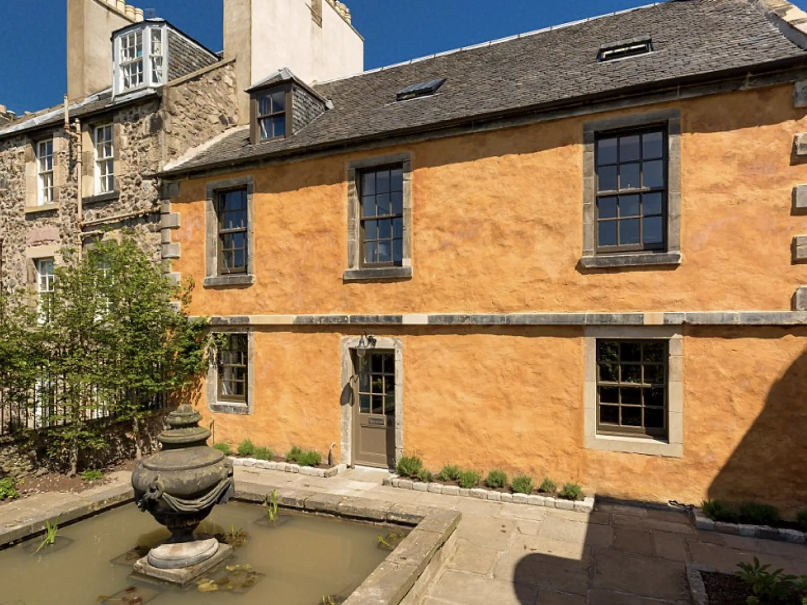 Rock House, Calton Hill: ochre limewash over lime on a random rubble wall