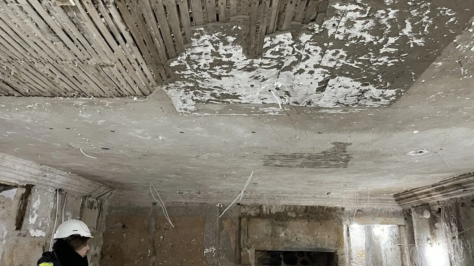 A lath and plaster ceiling opened up for consolidation: the laths exposed where the plaster had lost its key, the sound work left in place