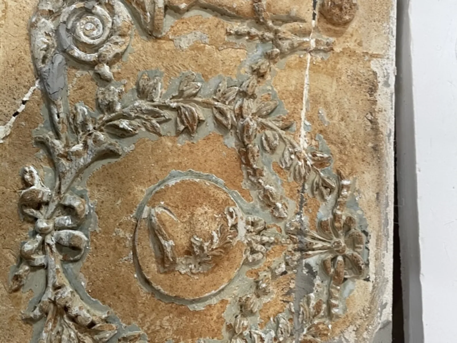 A surviving section of Georgian frieze, decayed and over-painted, before moulding