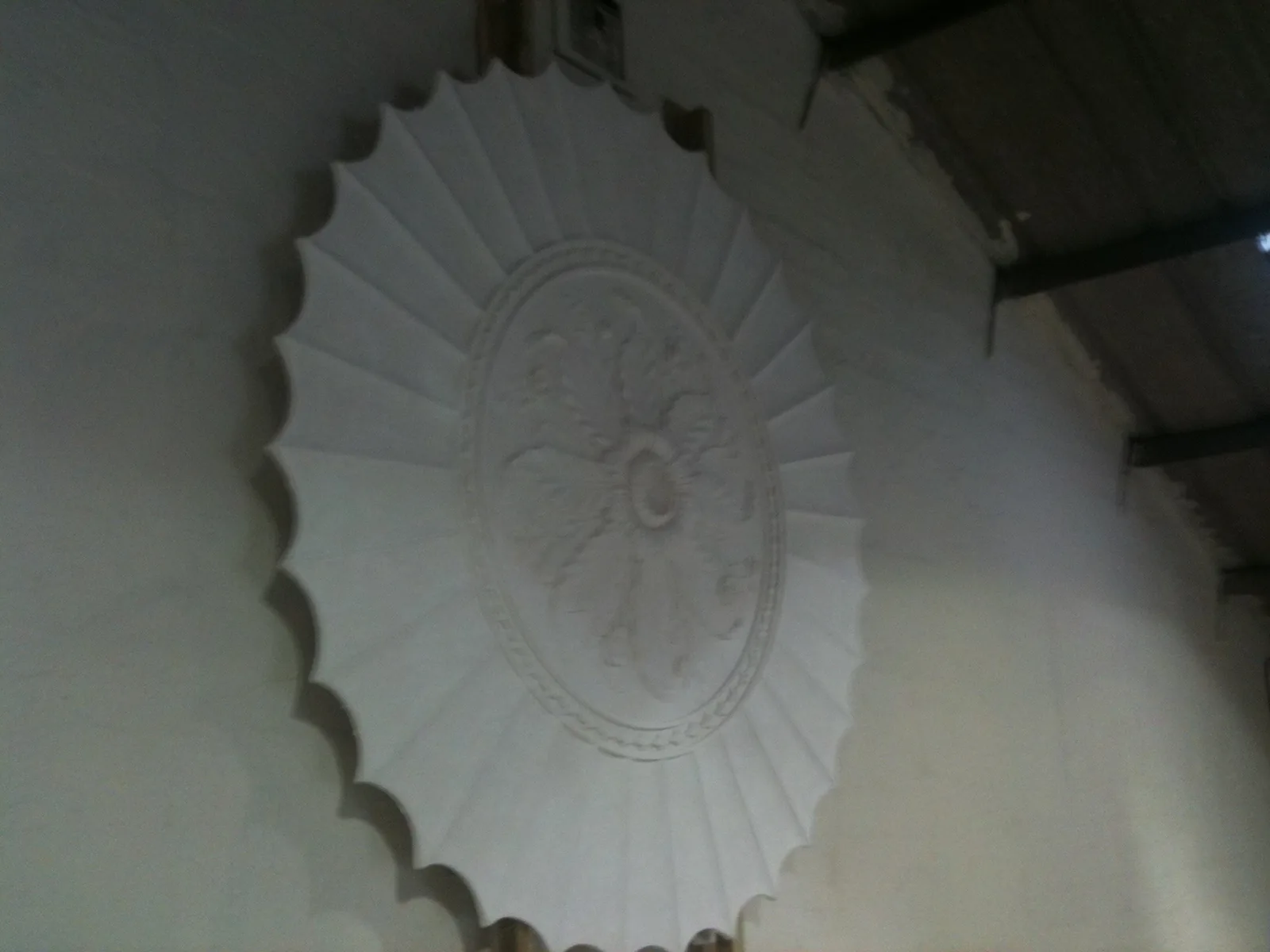 A new plaster ceiling rose within its fluted saucer dome, modelled and cast for a country house