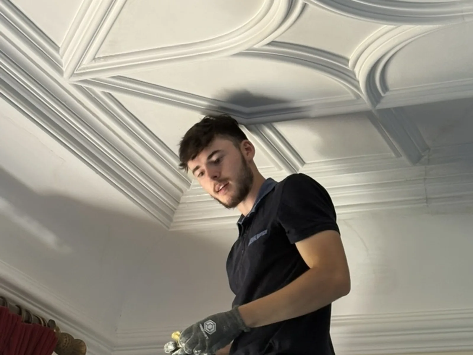 Consolidating a geometric ribbed plaster ceiling: working the junction between rib and panel before the surface is made good