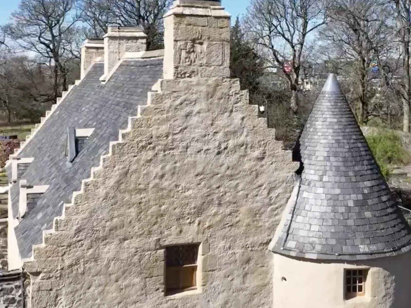 A crow-stepped gable and conical turret re-slated, with a new lead-dressed dormer