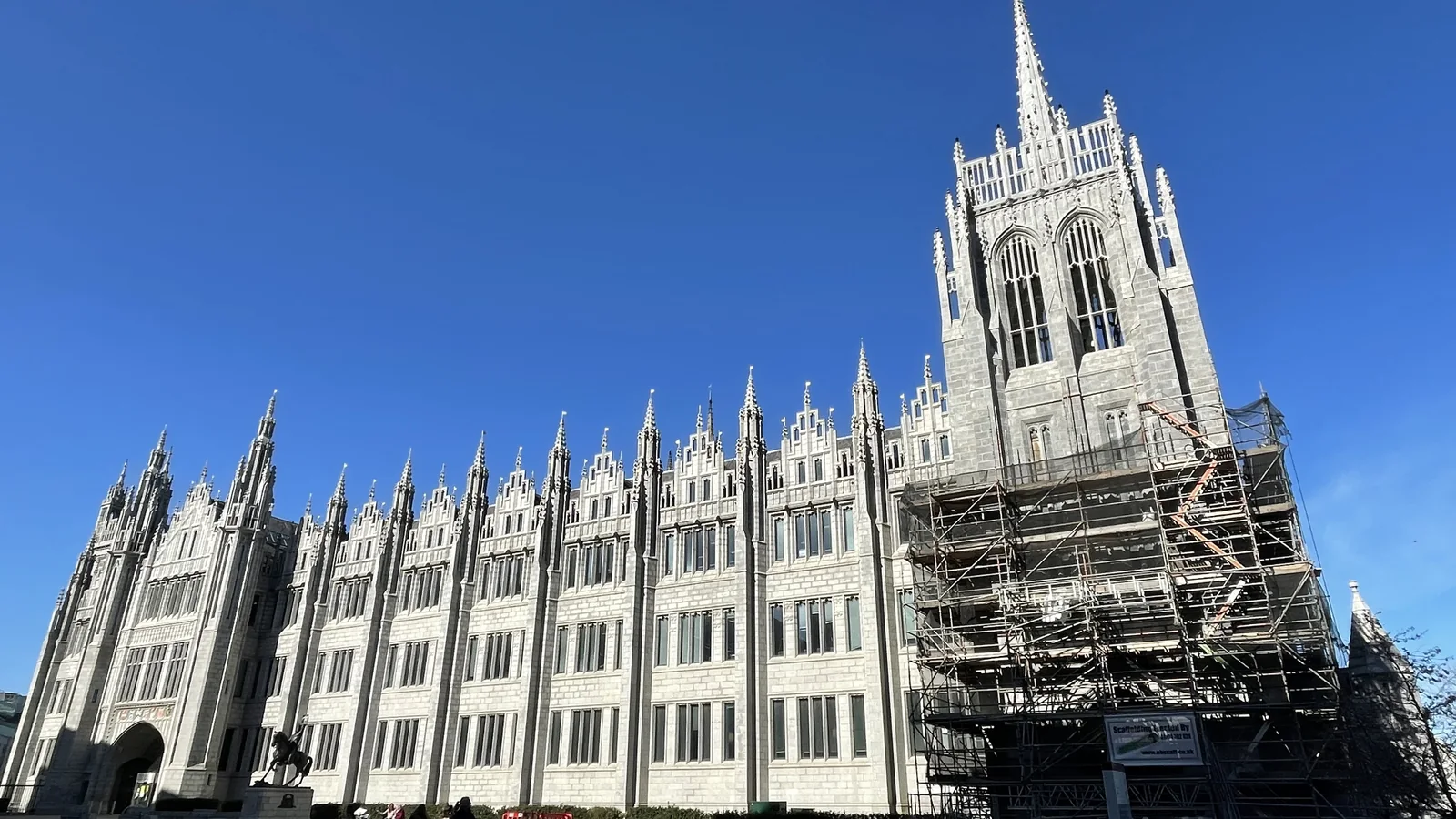 Greyfriars Church, Aberdeen: the Kemnay granite tower, belfry tracery and pinnacles cleaned, with the scaffold being struck downwards