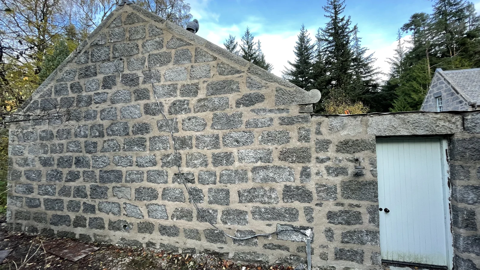 The same estate buildings cleaned, cement and paint removed, and repointed in a hot-mixed lime mortar