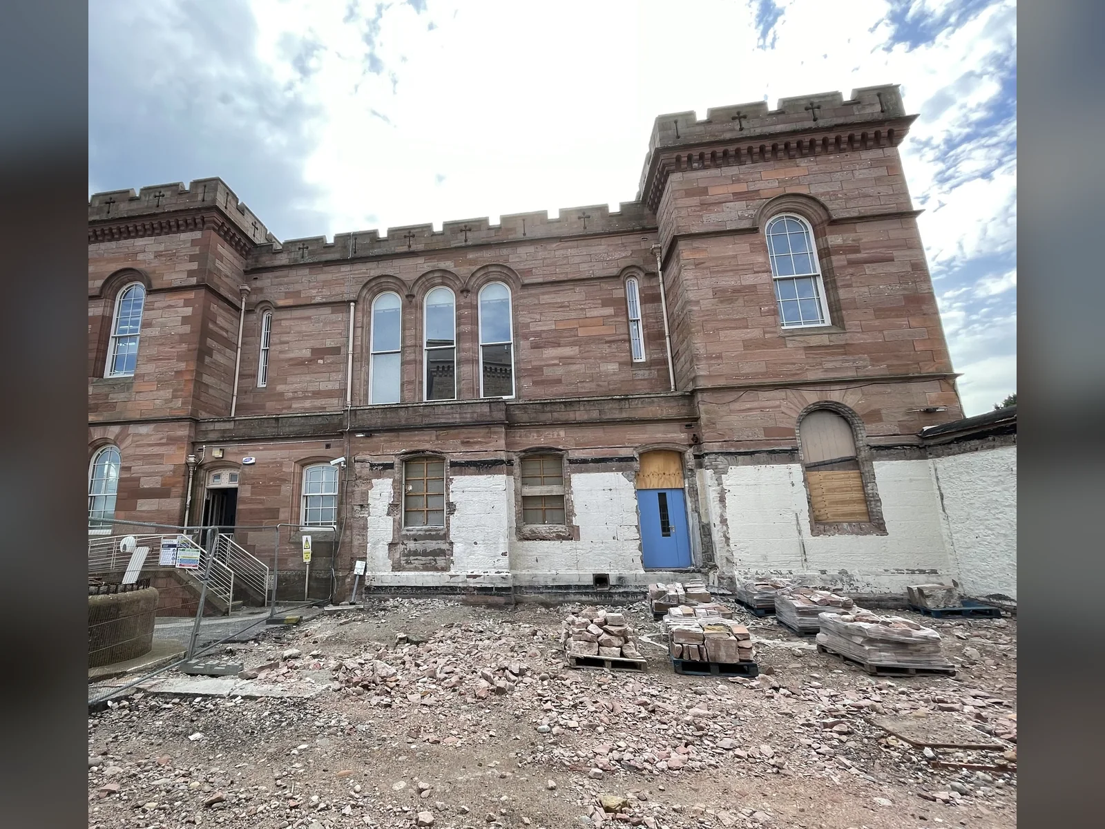 Inverness Castle before cleaning: the south tower's north elevation with decades of cement render and repairs coming off the red sandstone
