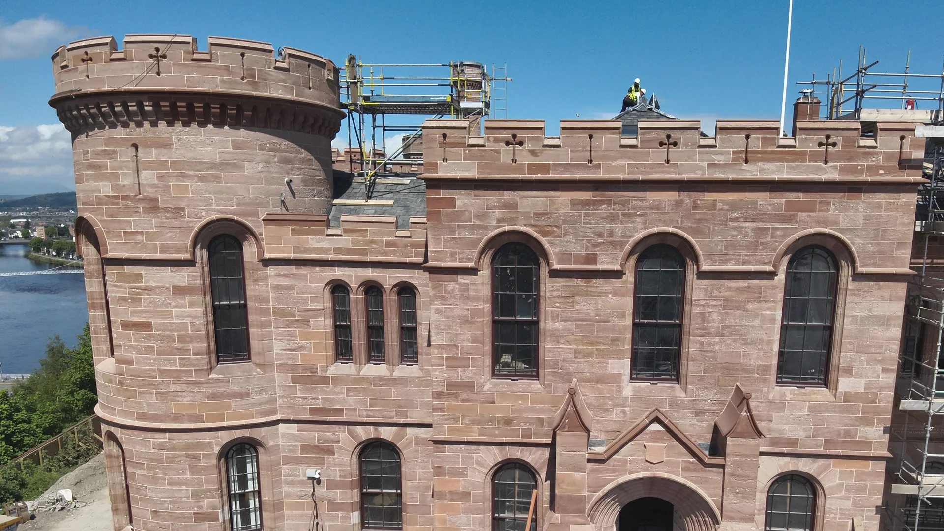 Inverness Castle: the red sandstone towers and entrance front cleaned with the DOFF steam system, seen from above with the scaffold coming down