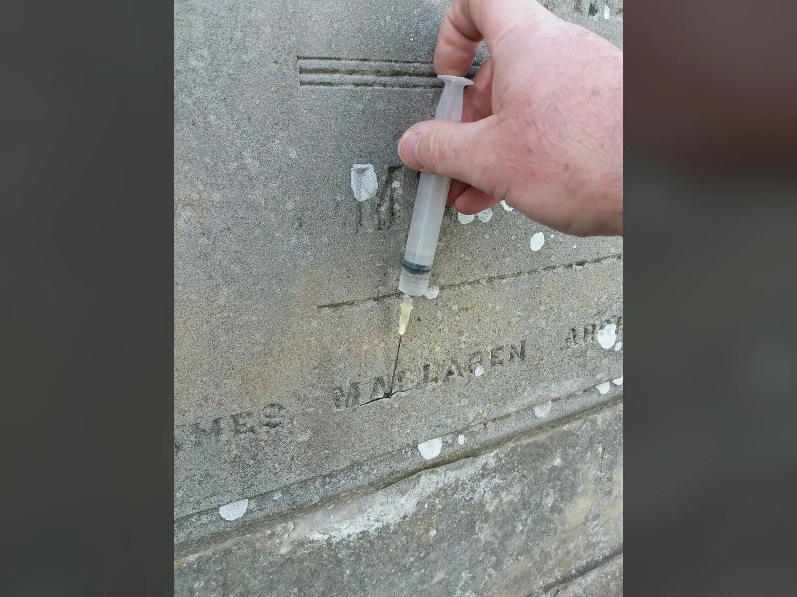 Consolidation in progress: Paraloid B72 injected by syringe behind the delaminating face of a sandstone memorial