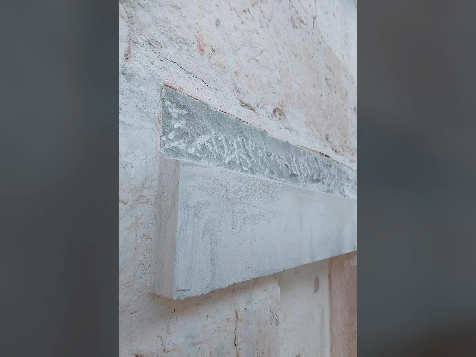 Eroded stone cut back to a sound face by our conservator, the hard cement and Lithomex patching removed