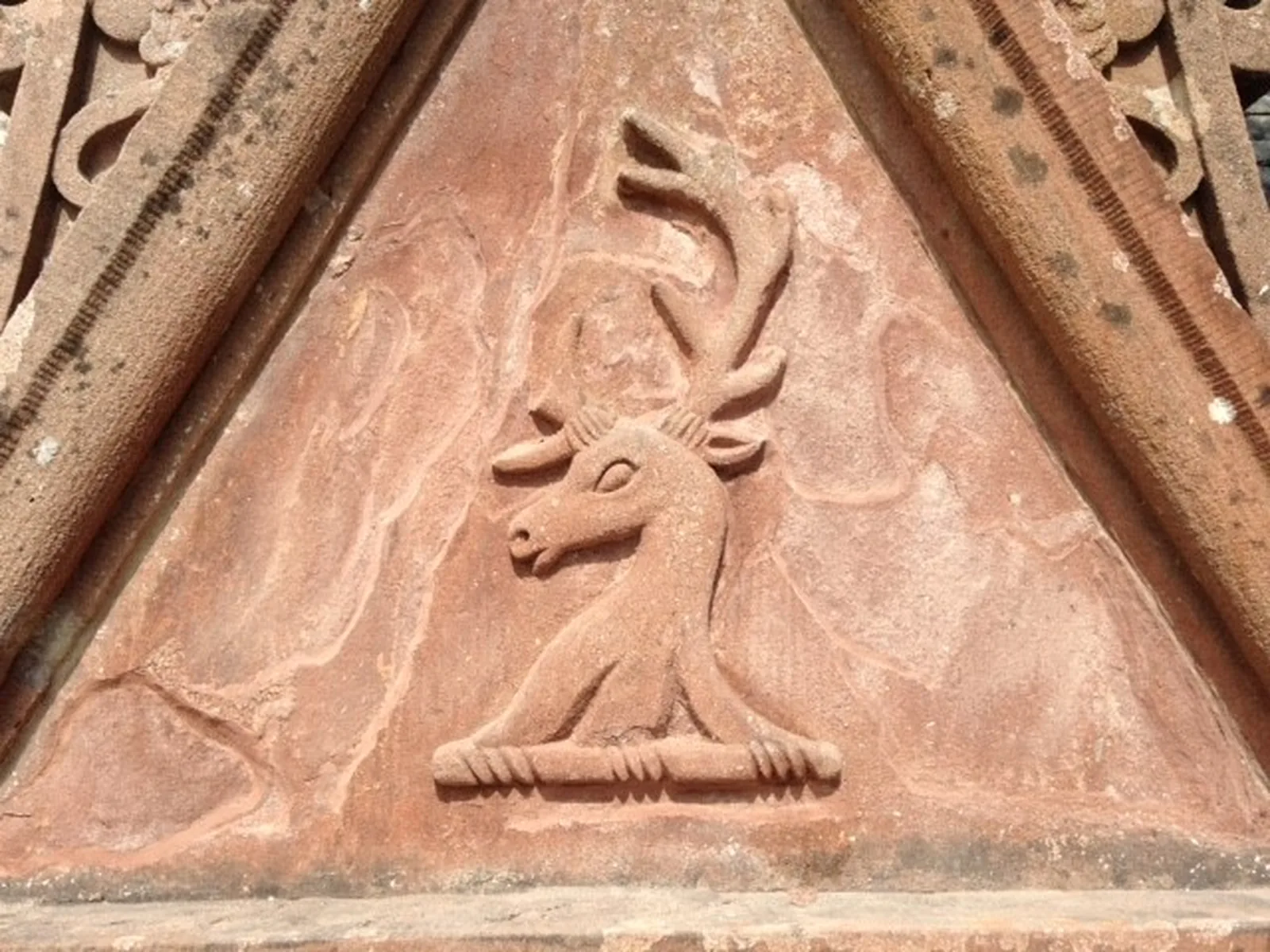 Aldourie Castle: the carved stag crest in the pediment, its lost antlers reinstated