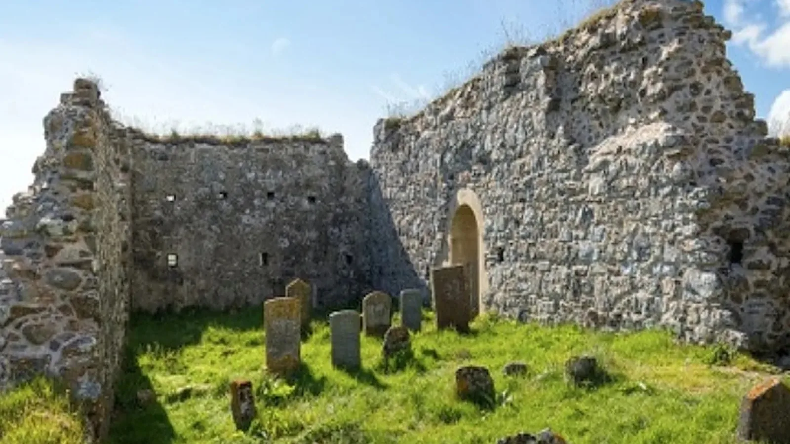 Teampull na Trionaid, North Uist: gravestones and plaques straightened and repaired within the ruined medieval church