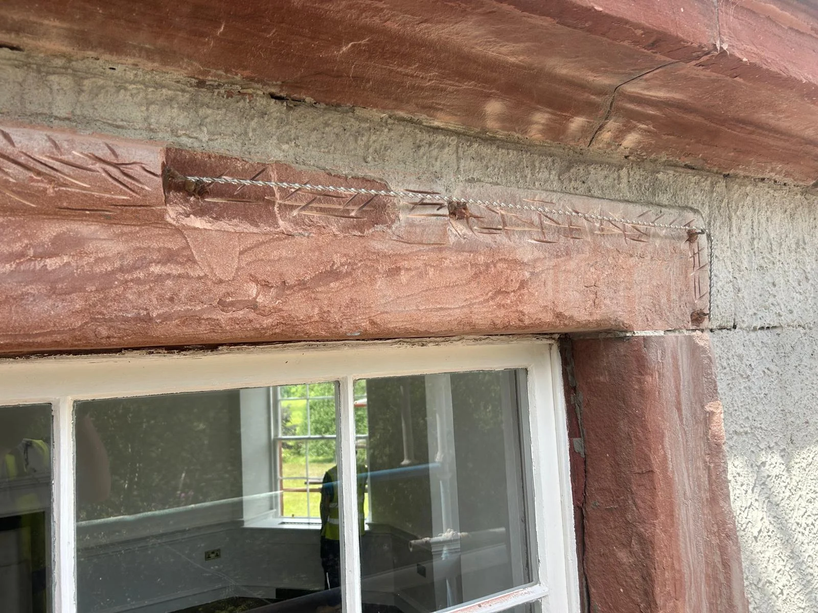 Stainless steel helical armatures pinned into the keyed stone to carry the new mortar moulding