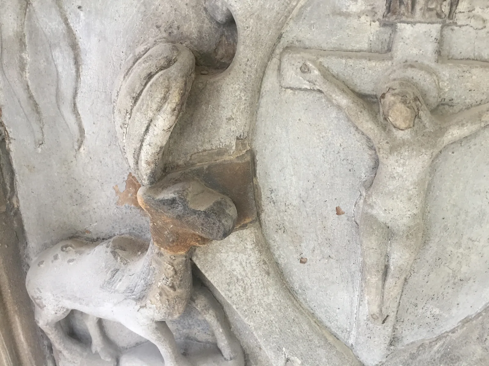 A lost fragment of the carving replaced with a small indent of matching stone, pinned into the original before being carved back to the line of the old work
