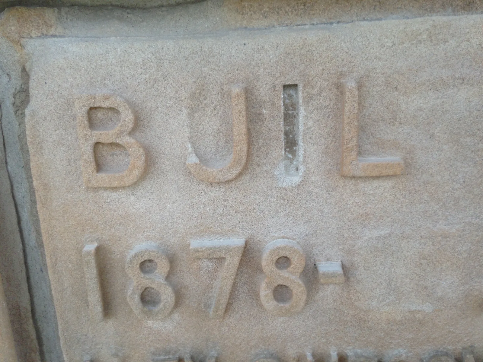 The 1878 date stone to Provost Alex Simpson as found, with the T of Built, the last two figures of the date and the full stop lost