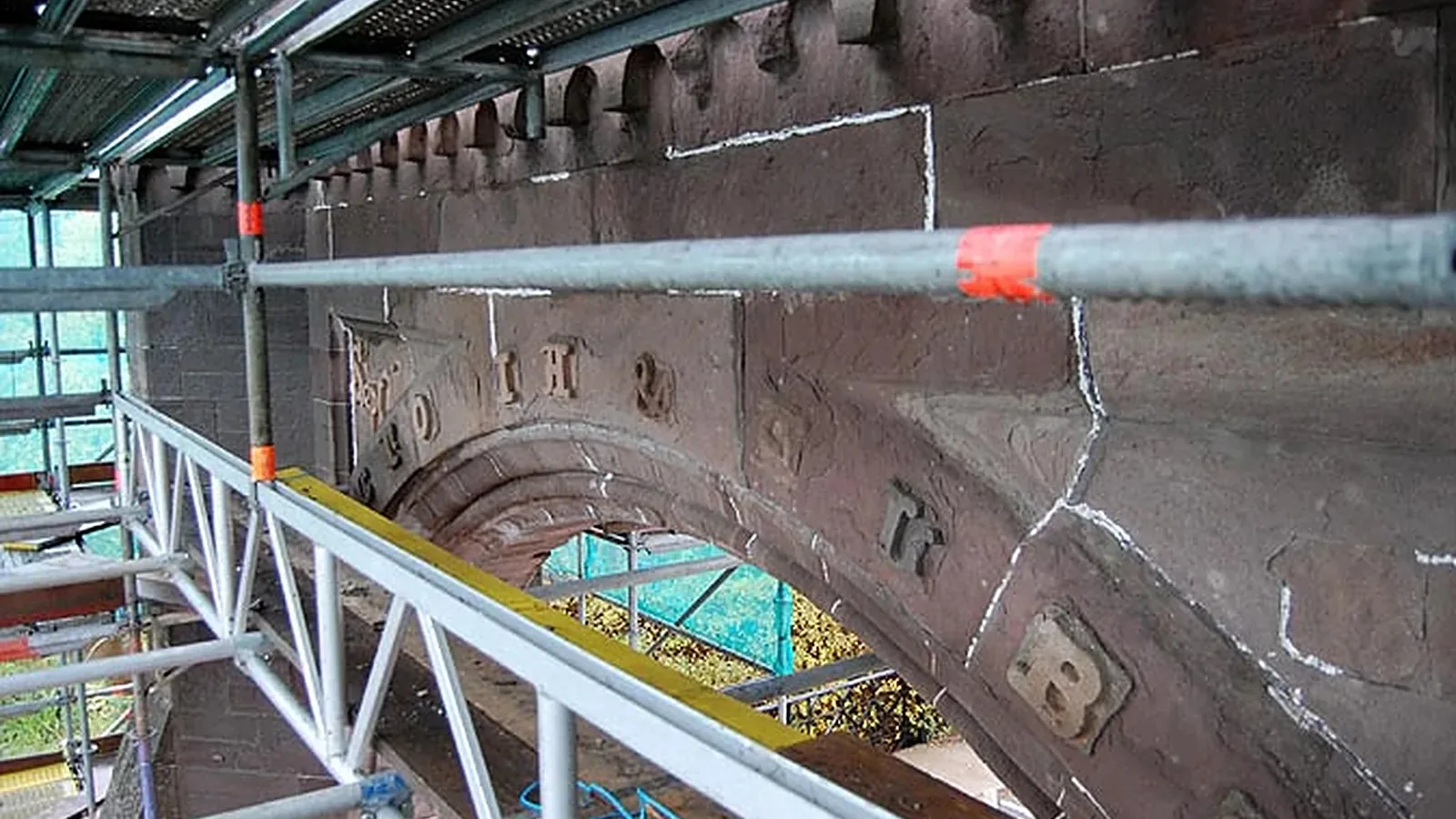 Fettercairn Arch: the Royal Arch inscription under scaffold, with cracks, losses and earlier plastic repairs marked up for conservation