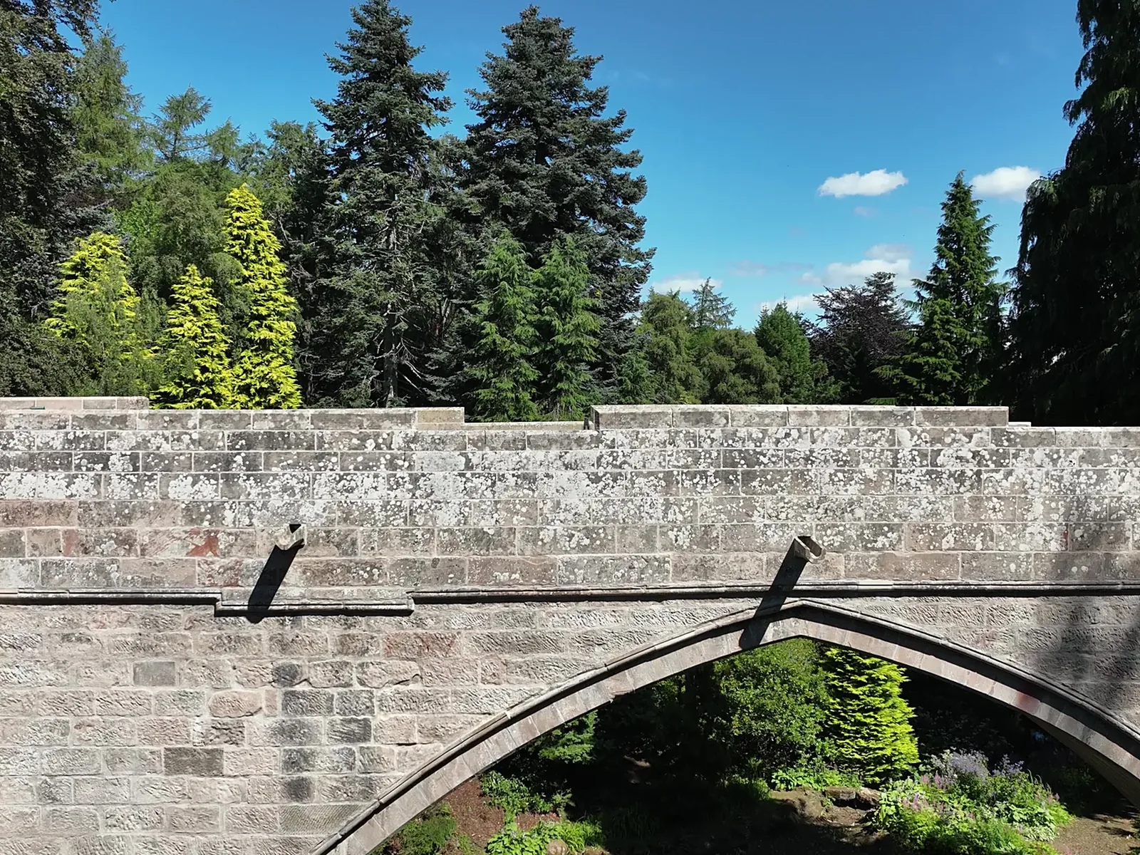 Back Den Bridge, Kildrummy: a Gothic arch estate bridge rebuilt in dressed stone with a new stone sett deck
