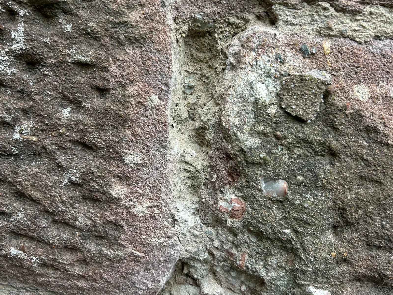 Destructive testing on the east gable: a chisel lightly worked into the lime joints to see how friable the mortar is and whether it has bonded to the sandstone