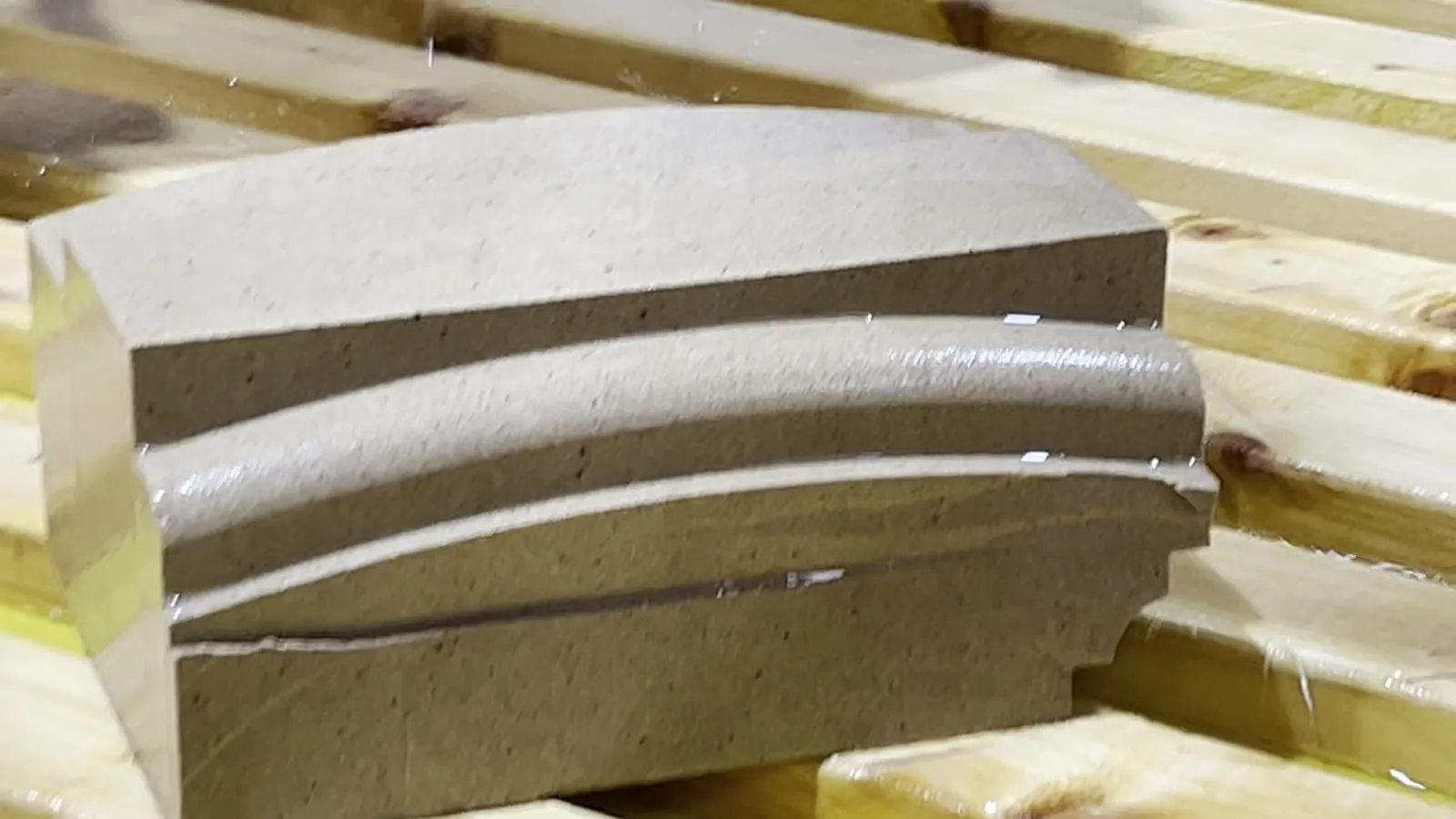 Moulded sections stacked on the saw bed, straight off the Litox